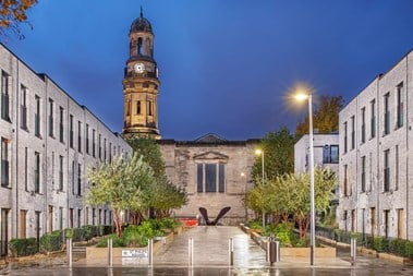 A view of a square of buildings which combines modern and historic buildings