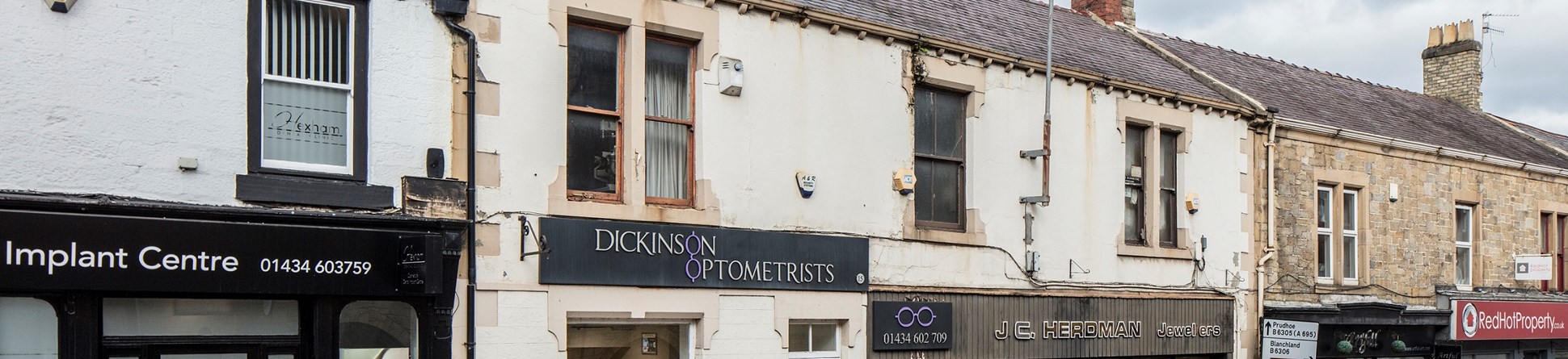 Hexham High Street Heritage Action Zone. 2019.Dickinson Optometrists and J.C.Herdman Jewellers,15 Battle Hill/ Priestpopple, Hexham, Northumberland. View from south east.