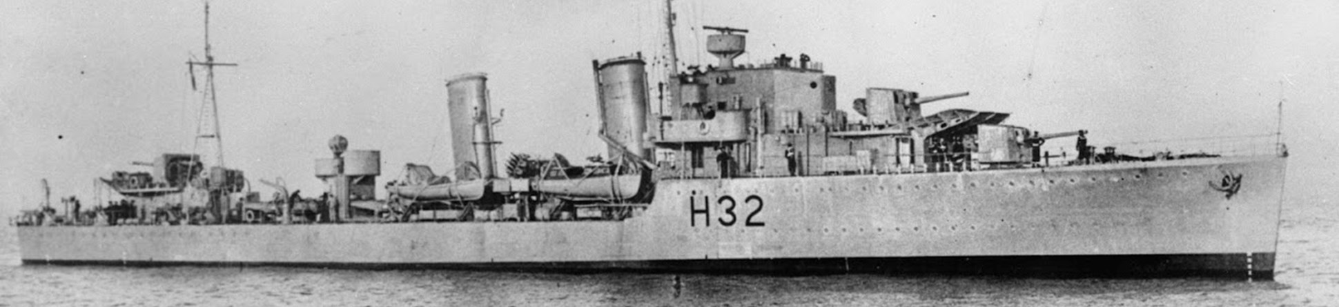 A black and white image of a Second World War destroyer ship on open water