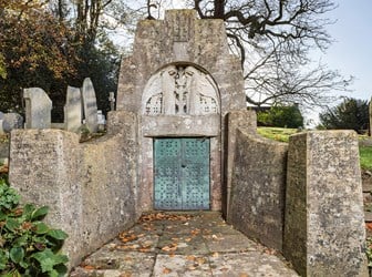 An Arts and Crafts style miniature mausoleum, constructed for a prominent local landowner and bearing the names of his family.