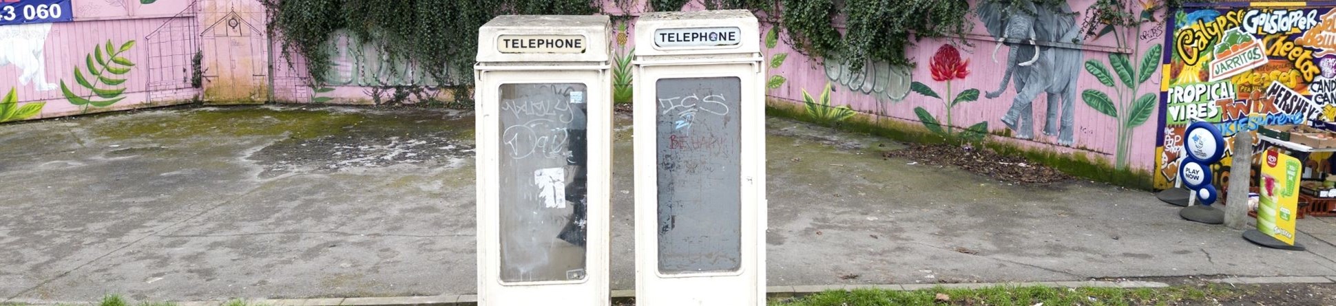 Two cream coloured phone boxes side by side. 